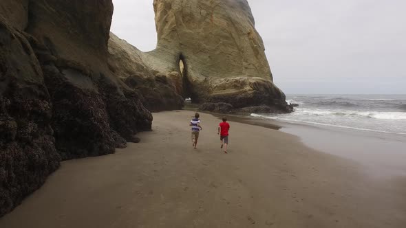 Two boys running on beach