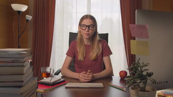 Young Woman Sitting at Desk, Home Work, Looking Camera Seeing Something Interesting, Shocked