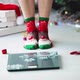 Close-up of adult woman legs in socks with deer stand on scales measure weight. - VideoHive Item for Sale