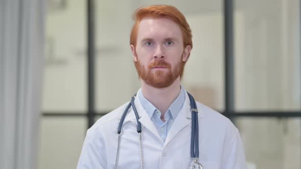 Redhead Male Doctor Looking at Camera