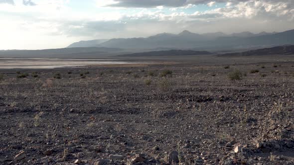 Arid dry ground in in Death Valley, Mojave Desert, California, Aerial flyover low shot