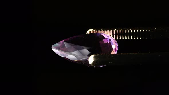 Natural Ametrine in the Tweezers on the Background