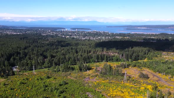 Slowly panning aerial footage of Vancouver Island during summer with the city of Nanaimo in front of