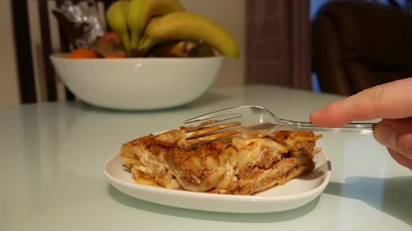 eating delicious lasagna