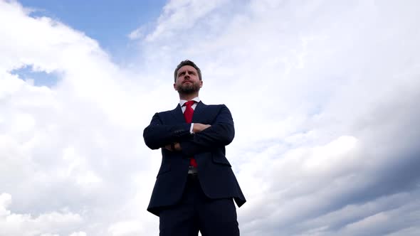 Successful Confident Man in Businesslike Suit Crossed Hands on Sky Background Business Success