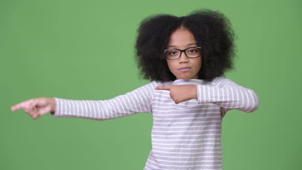 Young Cute African Girl with Afro Hair Showing Something