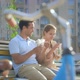 Happy Young Couple Resting After Cycling on a Bench on a Sunny Summer Day - VideoHive Item for Sale