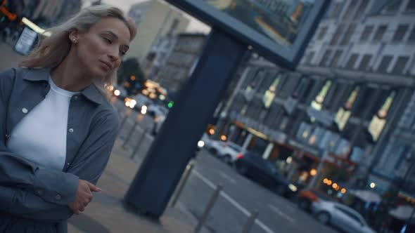 Attractive Girl Taking Walk Around Evening City in Traffic Lights