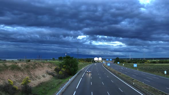 Nice timelapse with the traffic of a highway, with the sunset and dark clouds that announce the stor