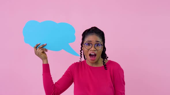 African American Girl in Pink Clothes Stands with Posters for Expression on a Solid Pink Background