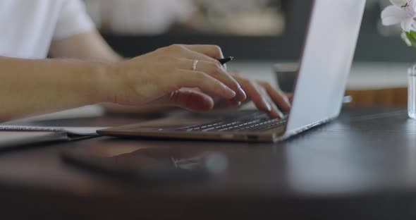 Man's Hands Typing Text on Laptop Keyboard and Using Smart Watch