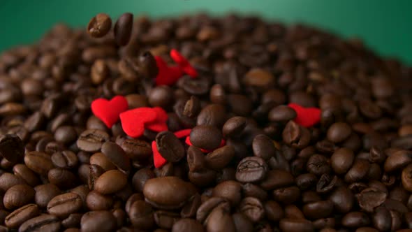 Slo-motion red hearts dropped into coffee beans