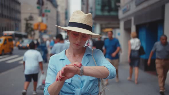 Young woman looking at watch in New York