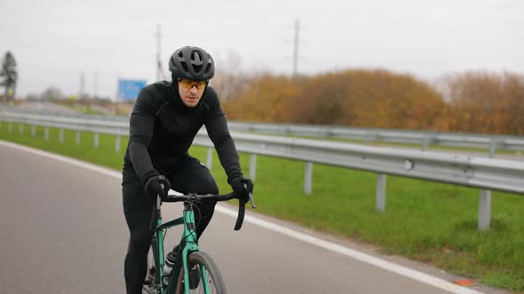 The Athlete is Training on a Bicycle