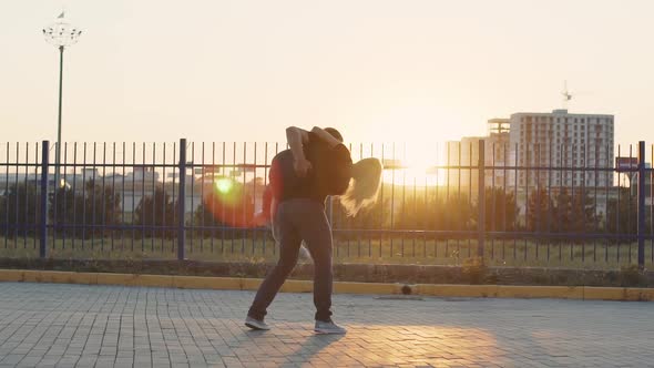 The Guy Picks Up His Girlfriend and Whirls with Her