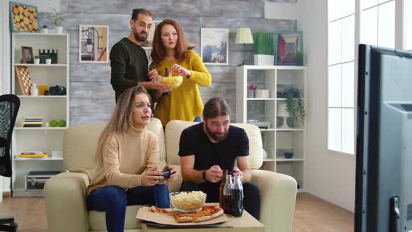 Happy Young Man After Winning at Video Games Against His Girlfriend