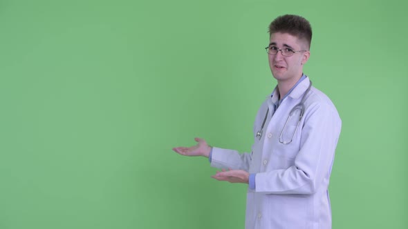 Stressed Young Man Doctor Showing To Back