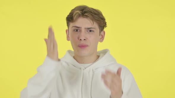 Young Man Fighting Arguing on Yellow Background