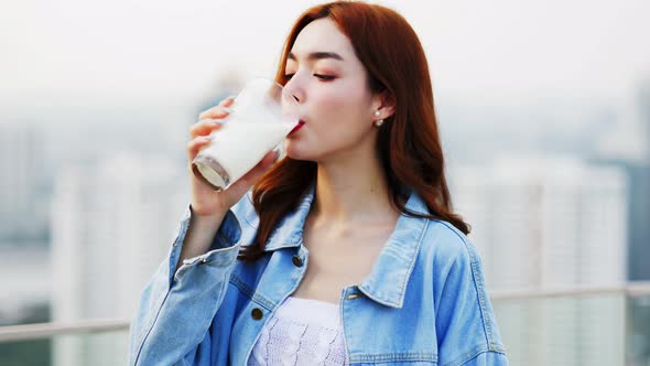 Asian young woman drinking milk.