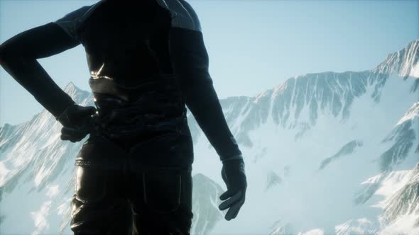 Woman Standing In Snow Wearing Warm Clothes In Mountains alt