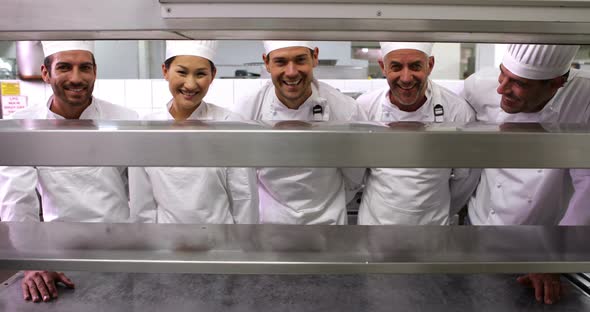 Smiling Chefs Standing in a Row at the order Station