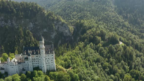 Fly Over Neuschwanstein Castle on the Background of Bavarian Alps Bavaria Germany