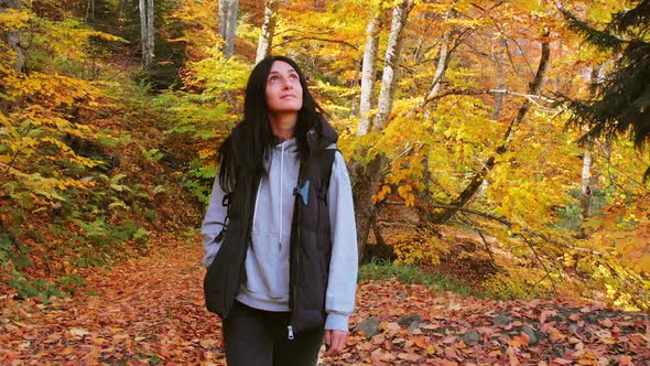 Woman Walks In Autumn Forest