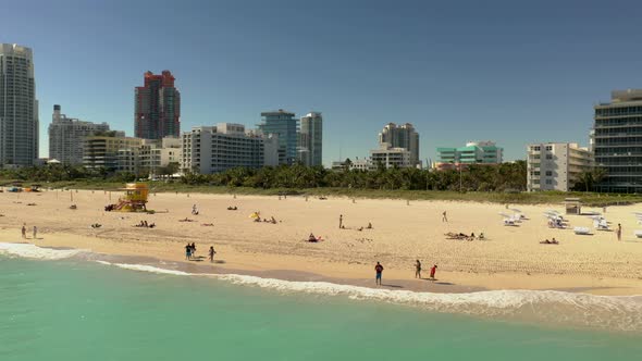 Aerial Footage People Walking By The Shore