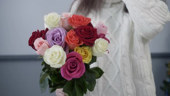 Woman in Sweater Holding Colorful Rose Bouquet