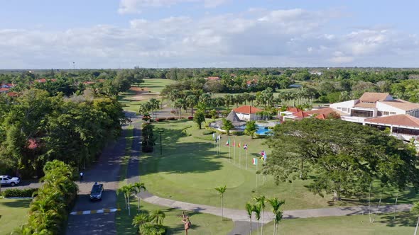 Aerial forward flight over luxury Metro Country Club Resort with garden,pool and palm trees in Juan