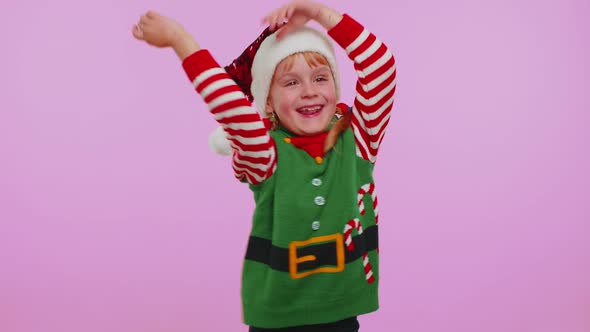 Crazy Girl in Santa Christmas Costume Demonstrating Tongue Out Fooling Around Making Silly Faces