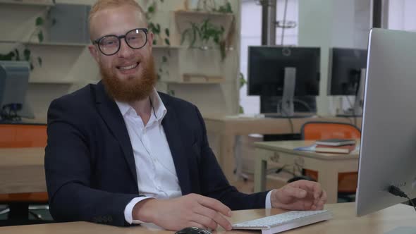 Bearded Man Laughs in Office