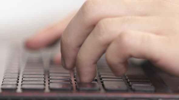 Close up view of fingers typing on a keyboard