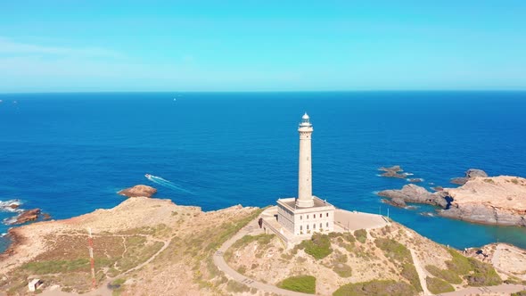 Aerial View of a Rock and a Lighthouse on the Sea