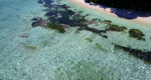 Wide fly over abstract view of a paradise sunny white sand beach and blue water background