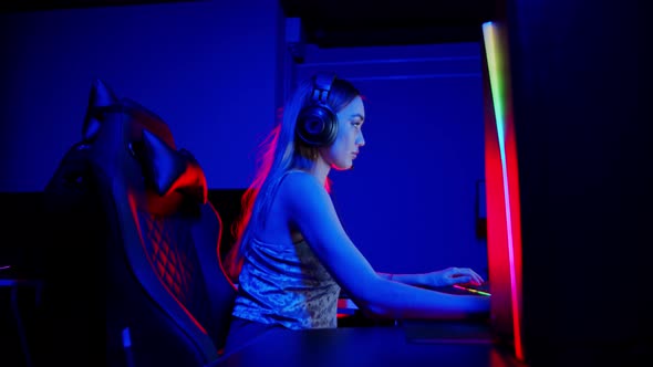 Tattooed Young Woman Sitting in Neon Gaming Club - Losing the Game and Gets Dissapointed