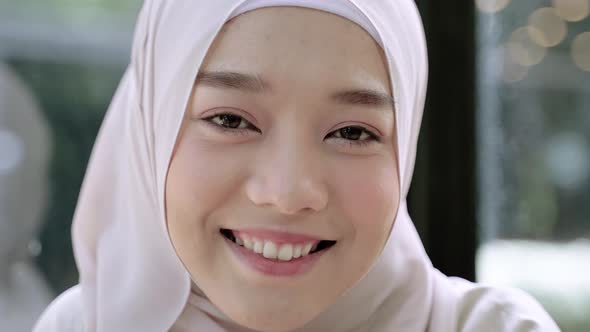 Close-up, beautiful Muslim girl smiling in hijab