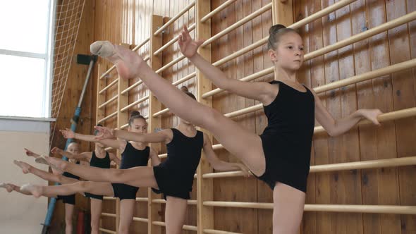 Girls Doing Gymnastics at Wall Bars