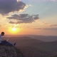 Epic Drone Shot of a Silhouette of a Young Freelancer with a Laptop on the Edge of a Rock Ledge in - VideoHive Item for Sale