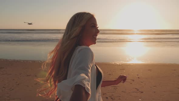 Attractive Blond Woman Walking on the Beach