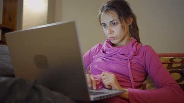 Thoughtful Concerned Woman Working on Laptop Computer at Home