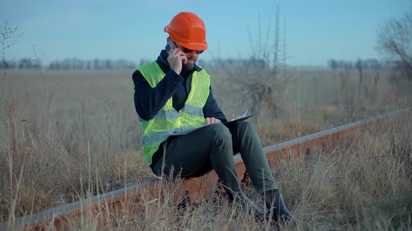 Foreman Designer On Train Station. Civil Engineer Developer With Helmet. Builder Constructor Foreman