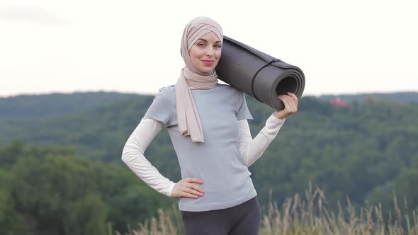 Woman in Hijab and Sport Clothes Smiling and Showing Thumbs Up Sign