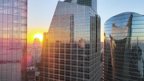 Cinematic close up aerial pan shot capturing reflective mirror glass window facade skyscrapers in do