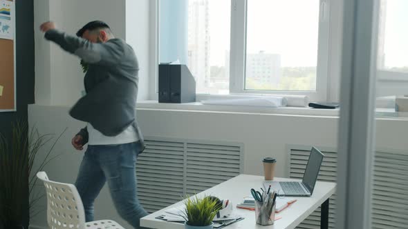 Slow Motion of Crazy Mixed Race Guy Dancing and Having Fun Indoors in Office Room