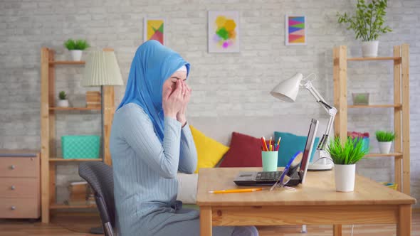 Young Muslim Woman in a National Headscarf Working at Laptop Feels Pain in Eyes