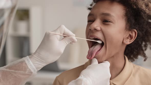 Boy Getting Saliva Sample Collected