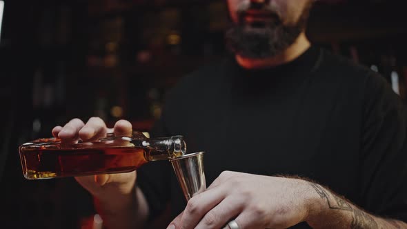 Bartender Measures Liquid Cocktail Ingredient with Jigger