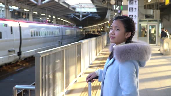 Asian Girl Waiting  Express Train On Railway Station