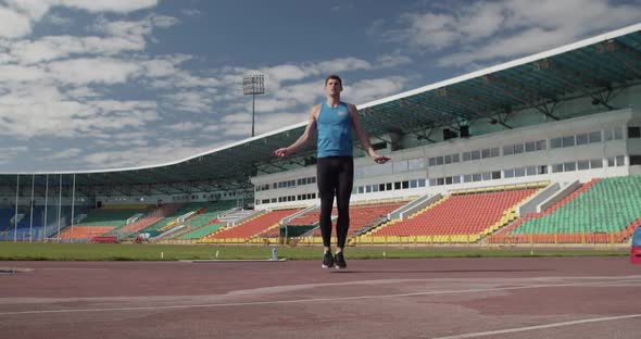 Sportsman Jumping with Rope on Stadium